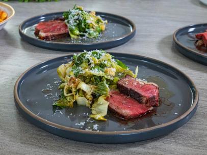 Host Selena Gomez and Chef Michael Symon's dish "Reverse Seared Bistecca Florentine w/ Herb Butter and
Escarole with Anchovy Garlic Breadcrumbs", as seen on Selena + Chef: Home for the Holidays, Season 5.