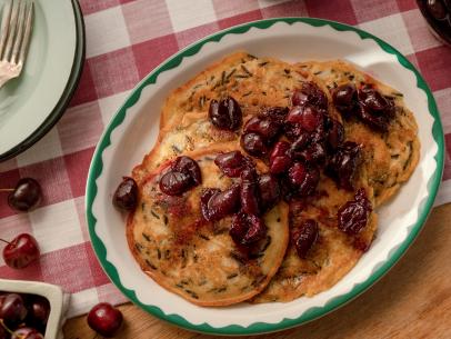 Beauty shot of Molly Yeh's Wild Rice Pancakes with Cherry Compote as seen on Girl Meets Farm, Season 12.