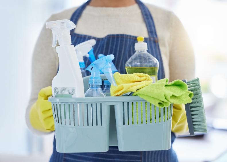 Woman, housekeeping products and cleaning container for home cleaner service, office maid and worker. Zoom on spray bottle, brush and fabric cloth for home spring clean and house hygiene maintenance