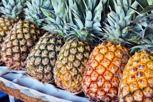 Pineapples on display in open market.