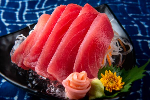 Tuna sashimi cutting raw blue fin tuna and serve in Japanese style food.