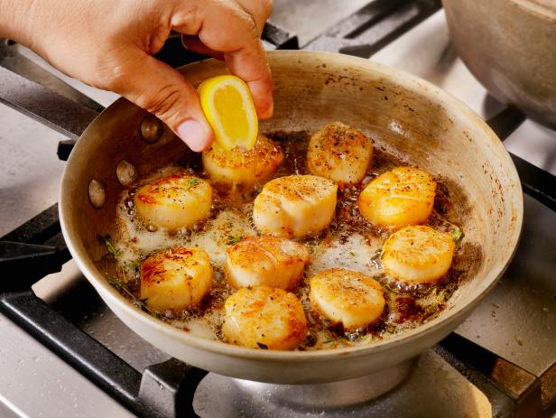 Pan Searing Scallops in Butter, olive oil and fresh garlic and thyme -Photographed on Hasselblad H3D2-39mb Camera