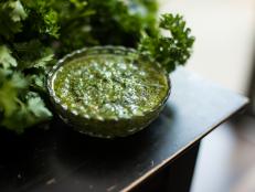 Chimichurri or chimmichurri is a sauce that originates from Argentina and Uruguay. It is made of finely chopped parsley, minced garlic, olive oil, oregano, and red wine vinegar.