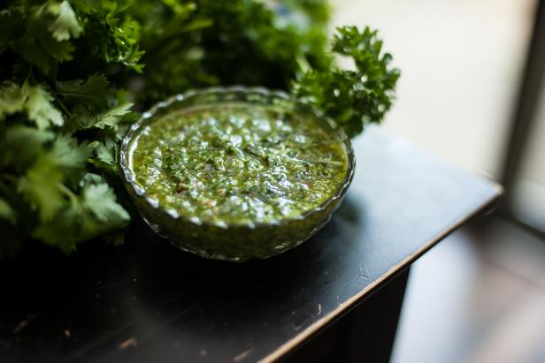 Chimichurri or chimmichurri is a sauce that originates from Argentina and Uruguay. It is made of finely chopped parsley, minced garlic, olive oil, oregano, and red wine vinegar.