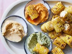 Buttery grilled corn is one of our favorite summer dinner staples. It’s even better with a trio of seasoned butters—think Cajun, miso and green goddess—served in shallow bowls so everyone at the table can roll an ear in their favorite flavor.