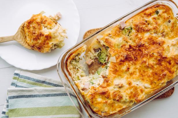 Top view of cauliflower, broccoli and cheese casserole in rectangular shape glass baking dish.