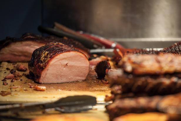 Picture of cooked Canadian bacon, also known as peameal, for sale on a market in downtown Toronto. Also known as Back bacon, it is a cut of bacon that includes the pork loin from the back of the pig.