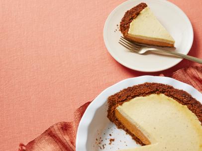 Duff Goldman’s PUMPKIN PIE WITH GINGERSNAP CRUST AND RUM CHEESECAKE TOPPING.