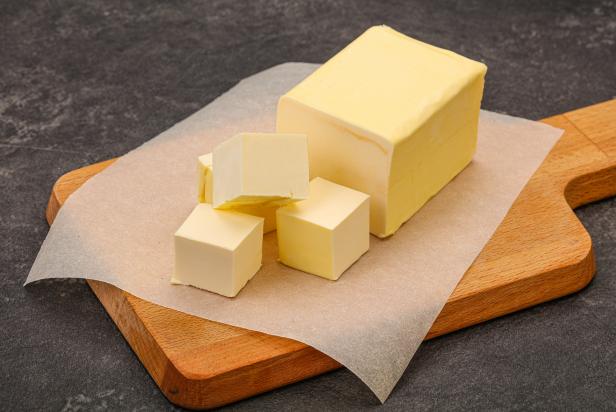 Dairy natural yellow butter piece over board