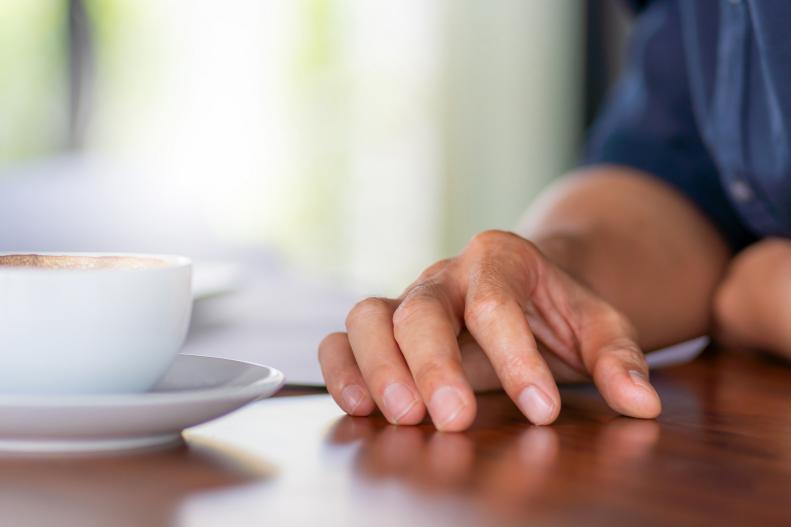 Selective focus of Casual young business engineer man hand with coffee cup and blurred background