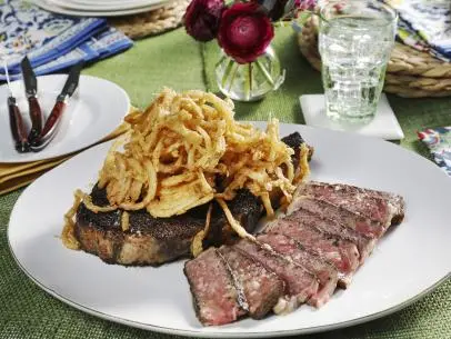 Kardea Brown's Spiced Rubbed Rib Eye Steaks w/ Frizzled Onions.