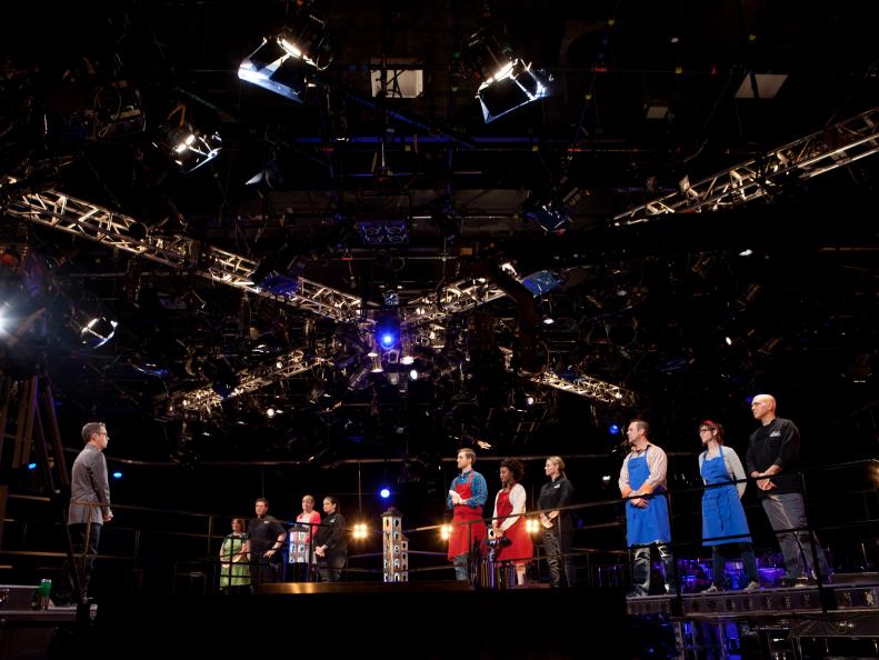 Six remaining cooks stand on the catwalk with their mentors before the start of the fourth round of competition, as seen on Food Network's America's Best Cook, Season 1.