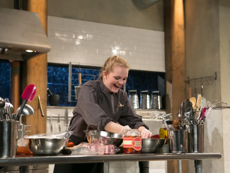 Teen Competitor Ashley Dudley (16) working on her appetizer that must include: cherry-drink-soaked pickles, lamb loin chops, kale chips and ricotta salata, as seen on Food Network's Chopped, Season 21.
