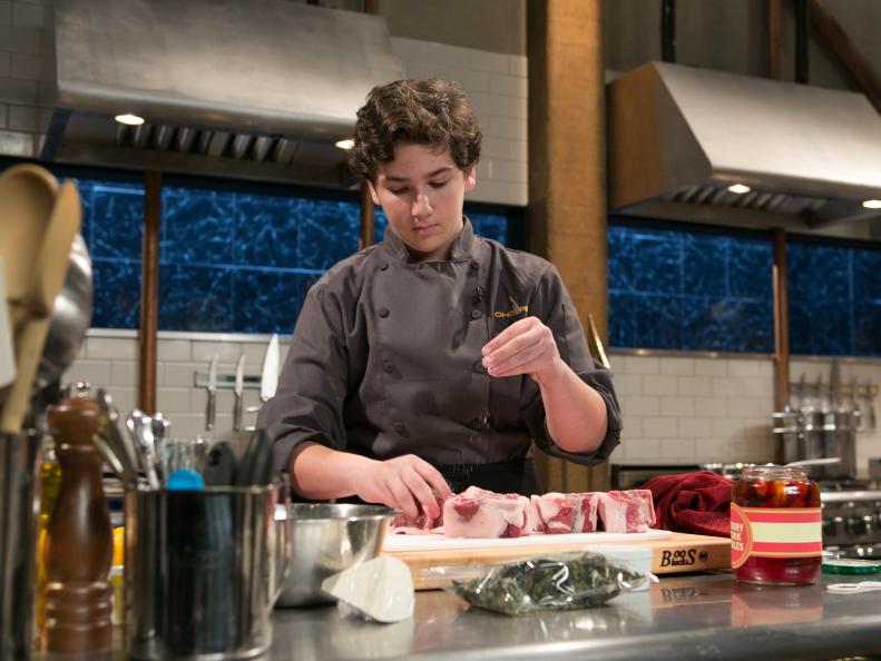 Teen Competitor Jason Khaytin (14) working on his appetizer that must include: cherry-drink-soaked pickles, lamb loin chops, kale chips and ricotta salata, as seen on Food Network's Chopped, Season 21.