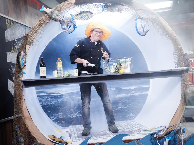 Chef Justin Warner prepares his Round 1 dish, Clam Sticks, in the Round 1 sabotage element, Weather Chamber, as seen on Food Network's Cutthroat Kitchen, Season 11.