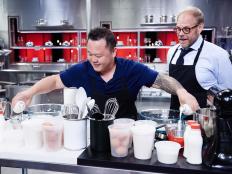 Host Alton Brown and Guest Judge Jet Tila with the Round 3 sabotage element Black and White Prep Station, as seen on Food Network's Cutthroat Kitchen, Season 11.