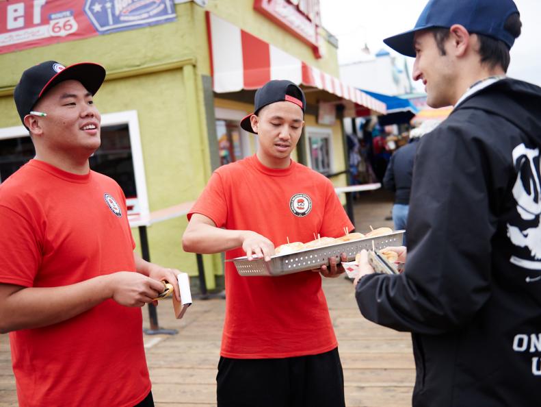 Team GD Bro Truck's Mark Cruz and Kevin Nguyen selling dishes for the Santa Monica Signature Challenge, as seen on Food Networkâ  s The Great Food Truck Race, Season 6.