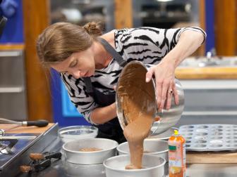 Contestant Stephanie Garcia pours her chocolate, and toffee cake batter into her baking trays for her 3D dog cake.  As seen on Food Network's Worst Bakers In America, Season 1.