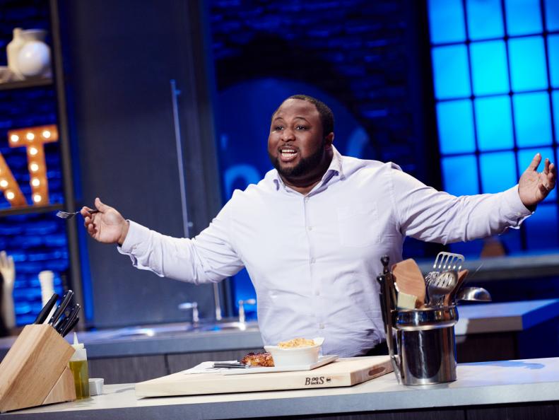 Finalist Jernard Wells presenting his dish, Orange Maple Chipotle Pork Chop with Lobster Mac and Cheese, for the Mentor Challenge, Cook For Your Life, as seen on Food Network Star, Season 12.