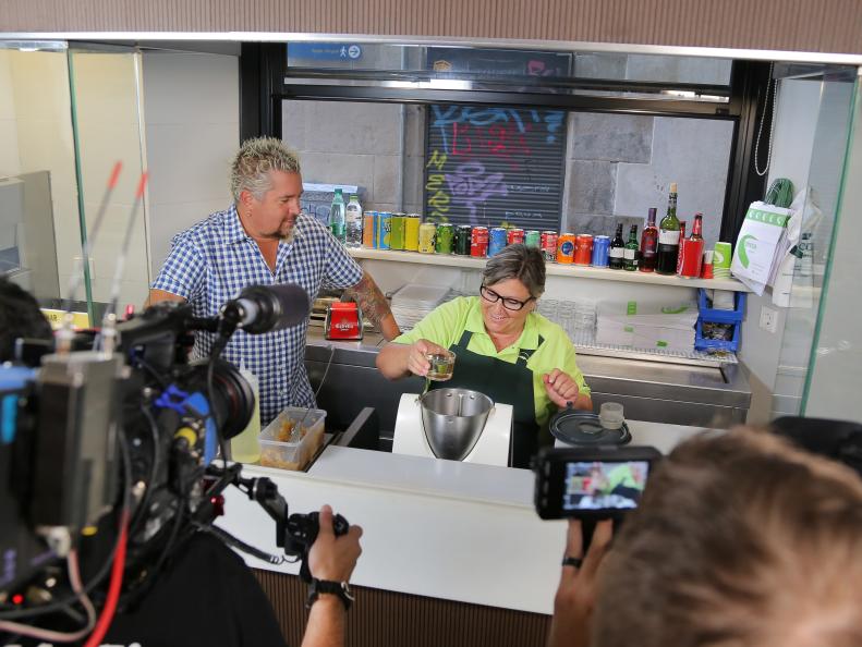 Behind-the-Scenes with Host Guy Fieri, Marta Conesa, and crew at Can Conesa in Barcelona, Spain as seen on Food Network's Diners, Drive-Ins and Dives episode 2601.
