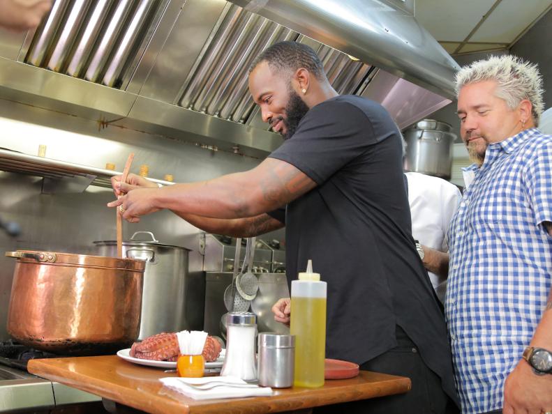 Host Guy Fieri, NFL Fullback Marcel Reese, and Owner and Chef Jose Luis Sierre at Pulperia a Gudina in Barcelona, Spain as seen on Food Network's Diners, Drive-Ins and Dives episode 2602.