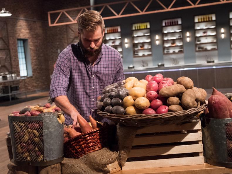 Contestant Cory Bahr choosing potatoes for the Mentor Challenge The Humble Potato, as seen on Food Network Star, Season 13.