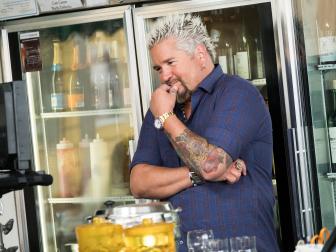 Guest Judge Guy Fieri directing Contestant Jason Smith filming his Pilot at the Farmers Market, as seen on Food Network Star, Season 13.