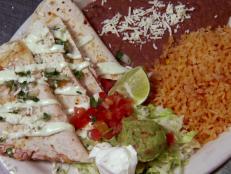 <p>If you want to eat Chef John Conley's giant Navajo Taco, you can use your fork and knife, or follow Guy's advice and dig in with your hands. The "King-Kong-meets-popover" tacos are Chef John's idea of Mexican cuisine that uses big flavors like cilantro cream sauce, roasted pork and fresh salsa.</p>