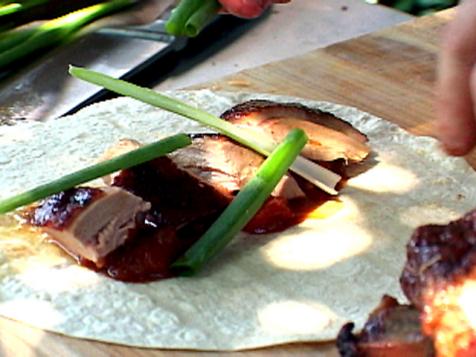 Rotisserie Duck with Hoisin Baste served with Grilled Oranges, Scallions and Pancakes