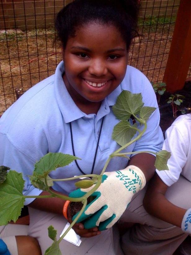 One of our Good Food Garden Ambassadors with her prized zucchini plant