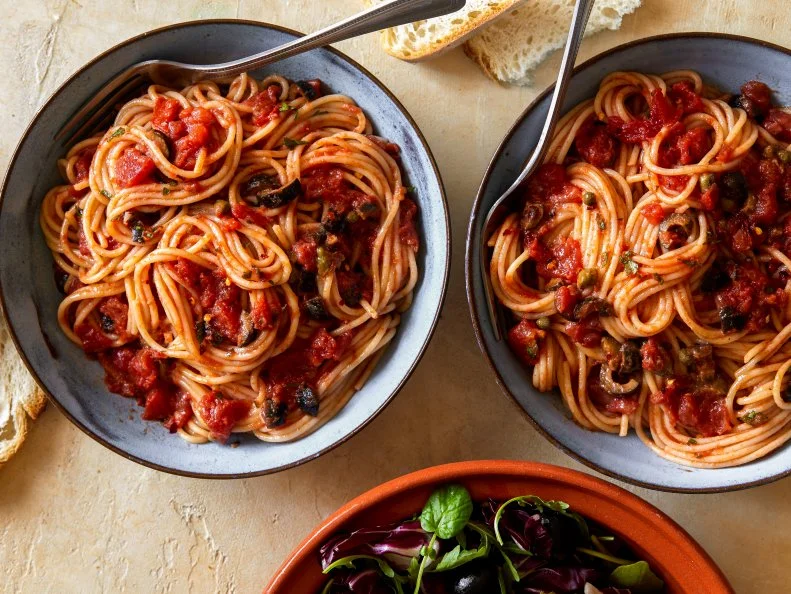 garlic, red pepper flakes, capers, diced tomatoes, parsley, spaghetti, crusty bread, parmesan, bitter green salad,