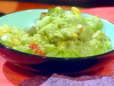 Amp up the flavor of this avocado-based Mexican dip by adding smashed garlic along with classic ingredients like cilantro, jalapeno and onion. Soaking the onions in cold water helps to remove some of the pungency of the raw red onion.