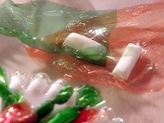 When making a sugar-based candy, any foreign ingredients like fat, acid-like vinegar or corn syrup help keep it smooth and from re-developing crystals. This is a smooth candy so it has all three. Taffy started in 1885 at Fralinger's on the Boardwalk in Atlantic City, N.J. The story goes that one day large waves came up and drenched all the product in the store, coating it with salt water. The next day when it was tasted they changed the name to "Salt Water Taffy." It became popular to have social events called Taffy Pulls to allow young men and women to get together and be close but not too close. Interesting old terms: crystallizing was called "graining" or "cause the candy to sugar."