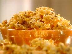 This is what I call real Chicago regional cuisine. Garrets, a popcorn shop in Chicago with lines out the door always, is famous for it's caramel corn and cheese corn. I love them both and have been known at times to mix the two for that favorite of flavor combinations, salt and sweet. Cracker Jack, the best known brand of caramel corn was invented and is produced in Chicago since 1893 when it was shown, of course, at the Colombian exhibition. We're known as the Candy Capital because of the large number of Candy Manufacturers that have made Chicago there home because of good railway systems to bring in ingredients from far away and plenty of corn all over the state to make the main ingredient, corn syrup. My favorite "toy surprise inside" was a miniature blue toaster with a piece of toast. It was about 1 inch big and I still have it in my charm collection with my play food. null You can, of course, use what ever your favorite kind of nuts are. Spanish peanuts are the classic, but think open-minded and try something different. Pistachios or pine nuts perhaps.
