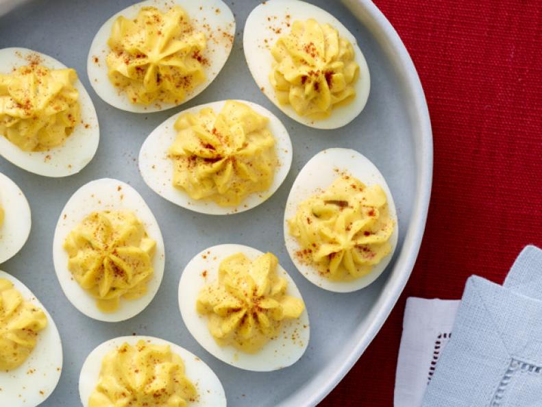 Deviled eggs served on an oval platter.