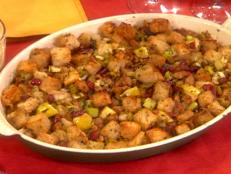 Serve a hearty side of Food Network's Sausage, Dried Cranberry and Apple Stuffing recipe for Thanksgiving dinner.