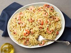 Dry white wine, butter and oil serve as the base for Tyler Florence's shrimp scampi sauce, as seen on Food Network.