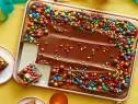 BIRTHDAY SHEET CAKEIna GartenBarefoot Contessa/Pooch PartyFood NetworkUnsalted Butter, Sugar, Eggs, Sour Cream, Vanilla Extract, Lemon, AllpurposeFlour,Cornstarch, Kosher Salt, Baking Soda, Semisweet Chocolate Chips, Heavy Cream, Light CornSyrup, Chocolate Candies
