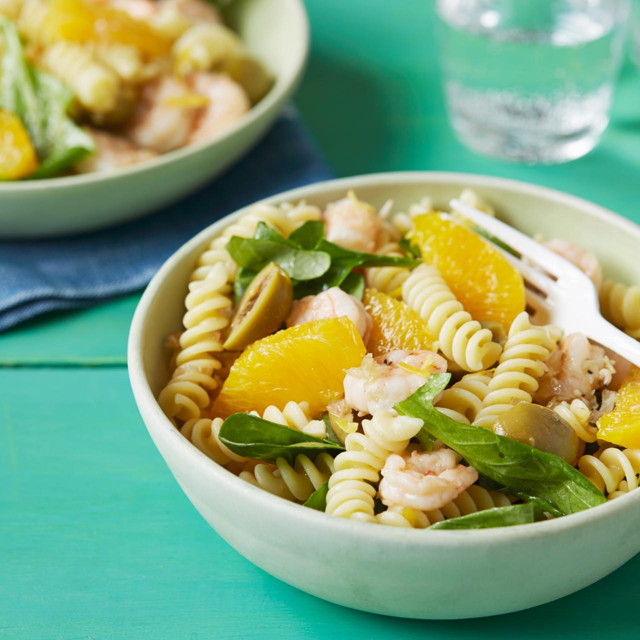 Fusilli, rigatoni and pens pasta in a green, blue and orange jar