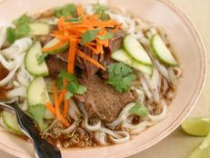 The Korean chile paste gochujang lends fiery heat to this rich and fortifying soup, made by slow cooking short ribs in chicken broth infused with soy, ginger, garlic and sesame. Rice noodles make the soup even heartier, while garnishing with fresh carrot, cucumber, cilantro and lime adds brightness and crunch.