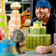 Duff Goldman Surrounded by a Variety of Decorative Cakes