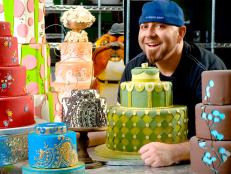 Duff Goldman Surrounded by a Variety of Decorative Cakes