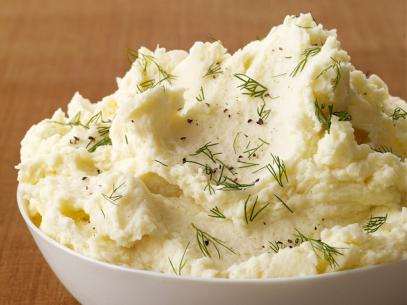 A Cream Bowl of Whipped Potatoes Piled High and Sprinkled With Herbs and Cracked Pepper
