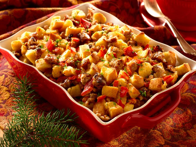 Super Moist Sausage and Bread Stuffing in a White and Red Dish With Handles on a Decorative Holidays Table Setting