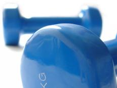 Closeup of Two Blue Dumbbells Against a White Background