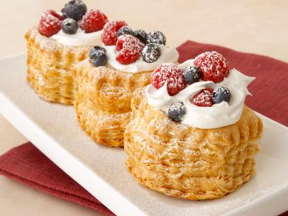 Three Red White and Blueberry Pastries aligned on a White Rectangular Dish 