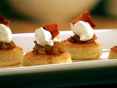 Puff Pastries Topped with Apples, Cream and Bacon on a White Dish