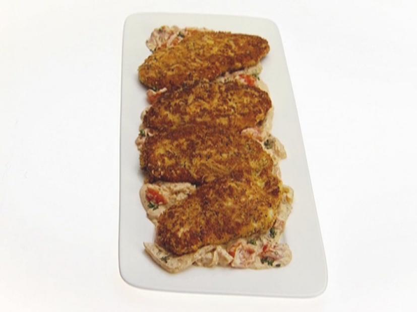 Chicken Milanese With Tomato and Fennel Sauce on a Narrow White Triangular Dish