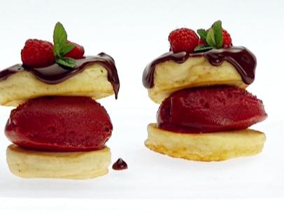 Raspberry Sorbet Sandwiched in Between Two Mini Pancakes and Topped With Chocolate and Raspberries