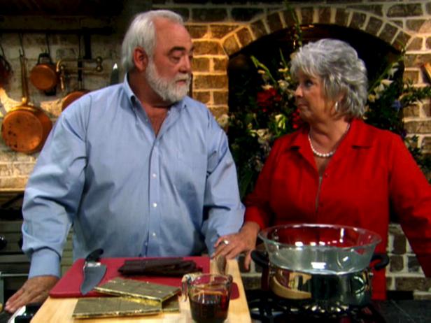 Paula and Michael looking at each other while standing in a kitchen